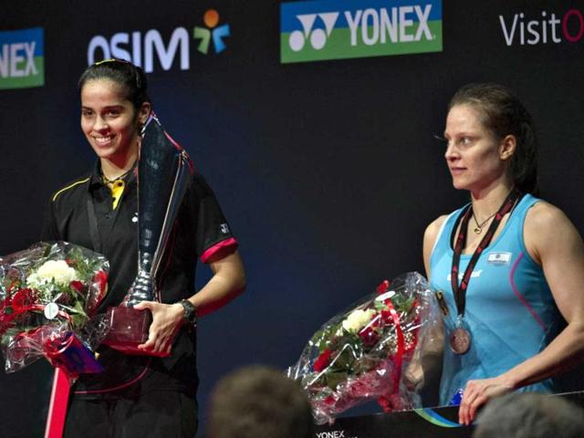 Saina Nehwal poses with the trophy after her victory against Juliane Schenk of Germany during their women's singles final match at the Danish Open badminton championship in Odense, Denmark. AFP Photo