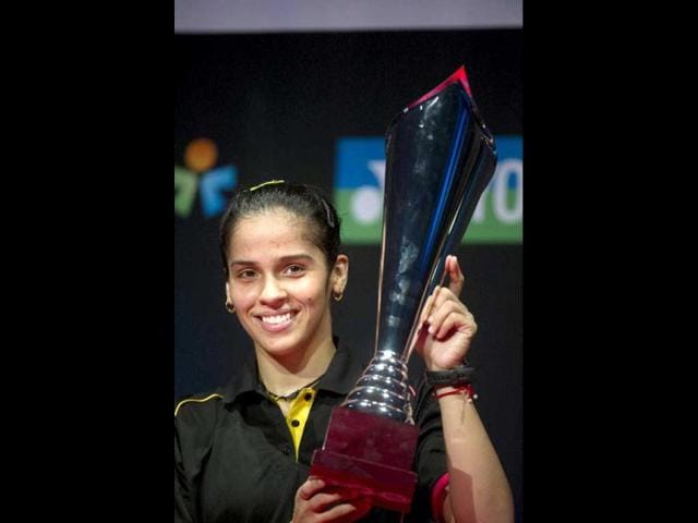 Saina Nehwal poses with the trophy after her victory against Juliane Schenk of Germany during their women's singles final match at the Danish Open badminton championship in Odense, Denmark. AFP Photo