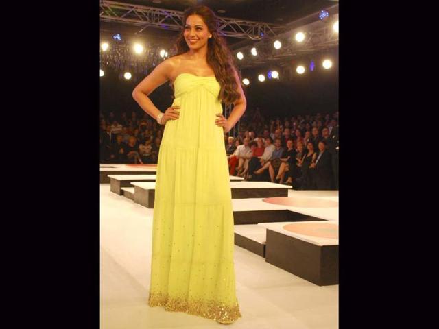 Bipasha Basu looked beautiful as she walked the ramp in a lime green gown with a gold-sequinned border.