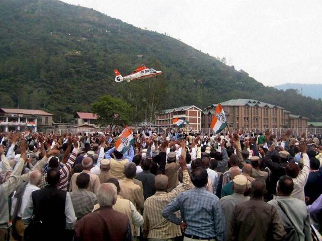 Supporters wave as Congress president Sonia Gandhi leaves in a helicopter after addressing an election rally in Mandi, Himachal Pradesh. PTI Photo