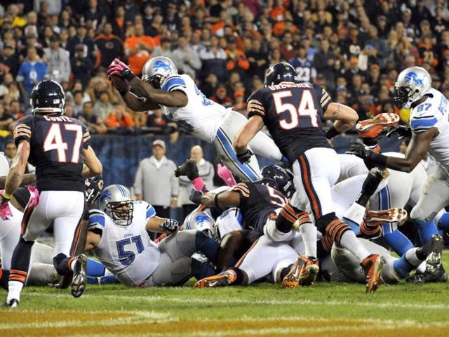 Joique Bell #35 of the Detroit Lions ties to dive into the end zone instead he fumbled the ball against the Chicago Bears at Soldier Field in Chicago, Illinois. David Banks/Getty Images/AFP