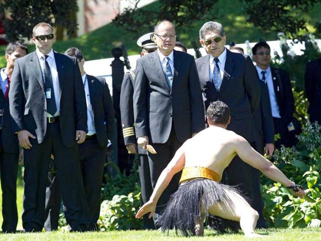 Philippine President Benigno Aquino (centre L) accepts a challenge from a Maori warrior (R) during a state welcoming ceremony at Government House in Wellington. Aquino is in New Zealand on a two-day visit before heading to Australia. AFP PHOTO