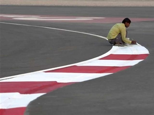 A worker paints the track of the Buddh International Circuit in preparation for the Indian Formula One Grand Prix in Noida, 38 kilometers (24 miles) from New Delhi. AP Photo/Tsering Topgyal