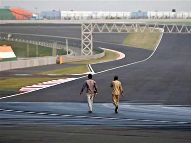 Workers walk at the Buddh International Circuit in Noida, 38 kilometers (24 miles) from New Delhi. AP Photo/Tsering Topgyal