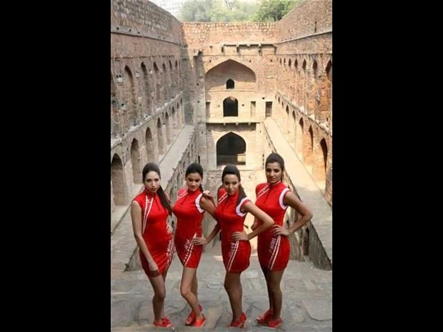 Formula One grid girls pose for photographers during a promotional event ahead of the Indian Formula One Grand Prix, in New Delhi. PTI Photo