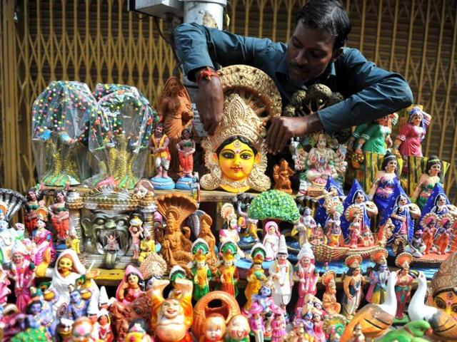 A vendor arranges statues of the Hindu goddess Durga on the occasion of the Dushhera-Vijaya Dashami festival in Hyderabad. (AFP Photo)