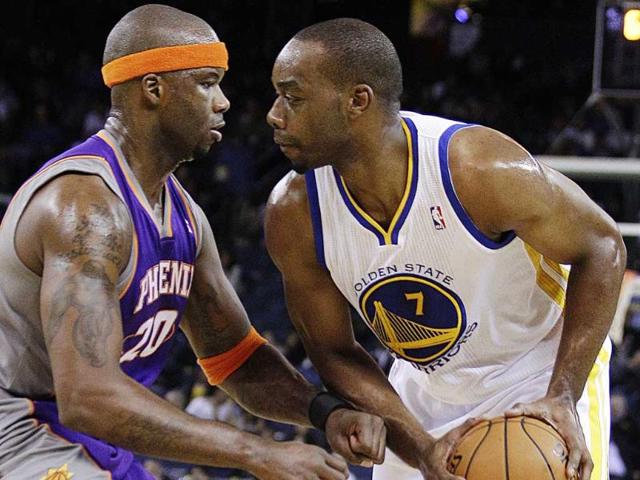 Phoenix Suns' Jermaine O'Neal, left, defends against Golden State Warriors' Carl Landry during the second half of an NBA preseason basketball game in Oakland, California. AP Photo