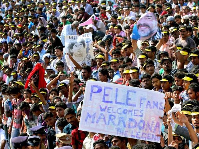 Fans gather at Jawahar Stadium to have a glimpse of footballer Diego Maradona in Kannur. PTI Photo