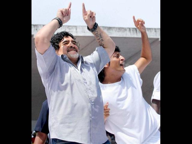 Football legend Diego Armando Maradona dances to Spanish tunes during a public reception at Jawahar Stadium in Kannur. PTI Photo