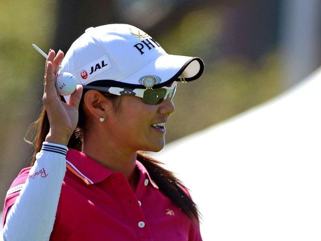 Ai Miyazato of Japan waves before teeing off at Sunrise Golf and Country Club in northern Taoyuan county. The $2 million tournament runs between October 25 - 28. AFP PHOTO