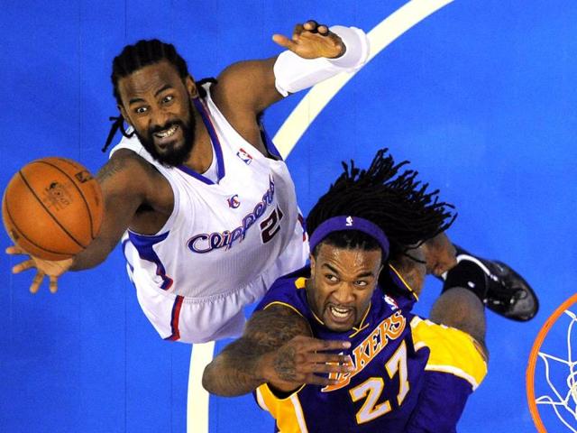 Los Angeles Clippers center Ronny Turiaf of France, left, and Los Angeles Lakers center Jordan Hill go after a rebound during the first half of their preseason NBA basketball game, in Los Angeles. (AP Photo/Mark J. Terrill)