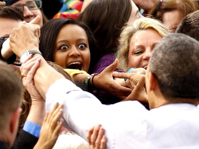 A woman reacts as she shakes hands with US President Barack Obama during a campaign rally in Denver, Colorado. Obama is on a two-day, eight state, campaign swing. REUTERS/Kevin Lamarque