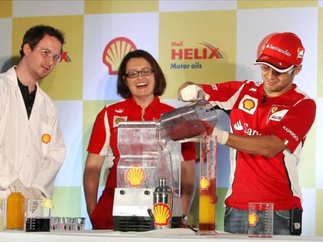 Ferrari driver Felipe Massa of Brazil makes a mocktail during previews for the Indian Formula One Grand Prix in Greater Noida. PTI Photo