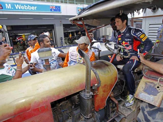 Red-Bull-Formula-One-driver-Mark-Webber-of-Australia-sits-in-a-tractor-in-the-pit-lane-at-the-Buddh-International-Circuit-in-Greater-Noida-Reuters-Photo Red-Bull-Formula-One-driver-Mark-Webber-of-Australia-sits-in-a-tractor-in-the-pit-lane-at-the-Buddh-International-Circuit-in-Greater-Noida-Reuters-Photo