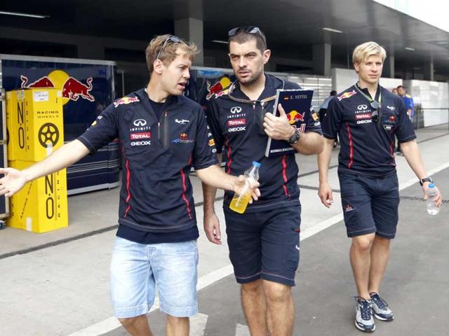 Red Bull driver Sebastian Vettel of Germany, left, walks with team members at the Buddh International Circuit ahead of the Indian Formula One Grand Prix in Greater Noida. AP Photo