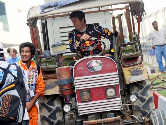 Red-Bull-Renault-driver-Mark-Webber-of-Australia-poses-in-a-tractor-at-the-Buddh-International-circuit-in-Greater-Noida-AFP-Photo Red-Bull-Renault-driver-Mark-Webber-of-Australia-poses-in-a-tractor-at-the-Buddh-International-circuit-in-Greater-Noida-AFP-Photo