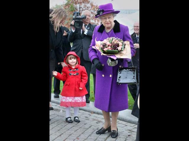Bethany Wiles aged three-years-old looks up at Britain's Queen Elizabeth II at the opening of the recently re-built Jubilee Gardens in London. AP Photo/Peter Macdiarmid