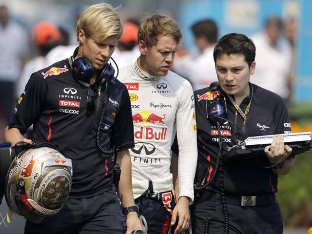 Sebastian Vettel walks down the F1 paddock with teammates following the first practice session for the Indian Formula One Grand Prix at the Buddh International Circuit in Noida. AP Photo