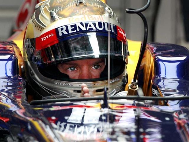 Sebastian Vettel waits in his pit garage during the first practice session for the Indian Formula One Grand Prix at the Buddh International Circuit in Noida. AP Photo