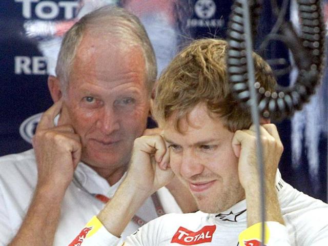 Sebastian Vettel (R) and Red Bull advisor Helmut Marko cover their ears inside their team garage during the first practice session of the Indian F1 Grand Prix at the Buddh International Circuit in Greater Noida. Reuters Photo