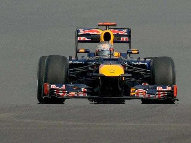 Sebastian Vettel drives his car during the first practice session of The Buddh International circuit in Greater Noida ahead of the Formula One Indian Grand Prix 2012. AFP Photo