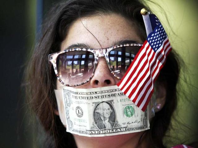 Krystal Maye joins protesters from political activist group 99 Rise in staging a sit-in at the entrance of a CitiBank branch office in Los Angeles, California. Five demonstrators were arrested for refusing to leave private property as they protested what they say are the bank's undisclosed political campaign expenditures. REUTERS
