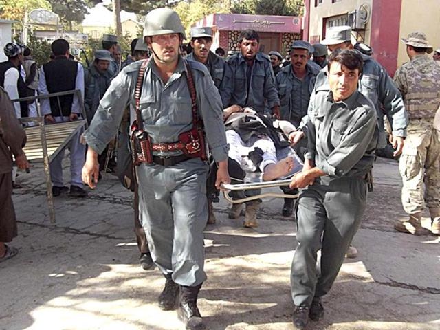 Afghan policemen carry the body of a civilian after a bomb blast in Faryab province. A suicide bomber killed at least 40 people in a mosque in Afghanistan's relatively peaceful north on Friday as worshippers gathered for prayers marking the Muslim Eid al-Adha holiday, police officials said. REUTERS