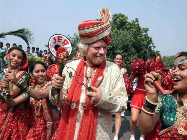 Owner of Virgin Group Richard Branson performs as he arrives for the launch of Virgin Atlantic’s service on the Mumbai-London route, in Mumbai. PTI Photo/Shashank Parade