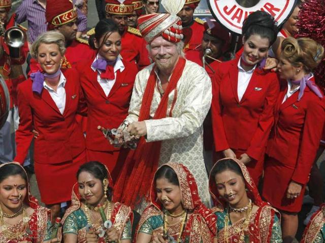 Virgin Group founder Richard Branson poses with his crew members and a group of Indian folk artists during a promotional event in Mumbai. Reuters/Danish Siddiqui