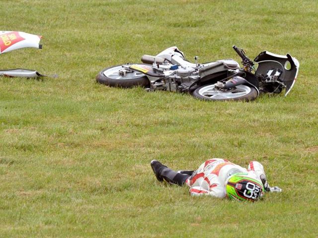 Honda rider Niccolo Antonelli of Italy lies on the ground after crashing during practice for the Moto3 class at the Australian Motorcycle Grand Prix at Phillip Island.