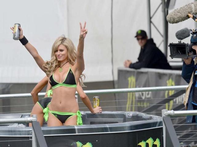 A TV crew films promotional girls braving cool conditions in a hot tub during MotoGP practice at the Australian Motorcycle Grand Prix at Phillip Island. (AFP Photo)
