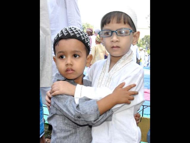 Children hug each other after offering Namaz during Eid al-adha at Maskshwa Idd-Gha Maidan in Guwahati. Agencies