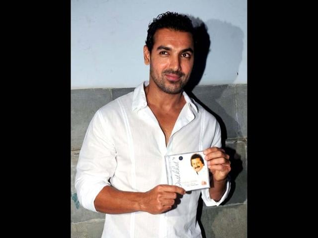 John Abraham poses with a CD of Pankaj Udhas new album Dastkhat. (Photo/AFP)