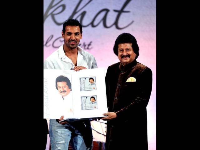 John Abraham poses for a photo during the unveiling of Pankaj Udhas' new album Dastkhat. (Photo/AFP)