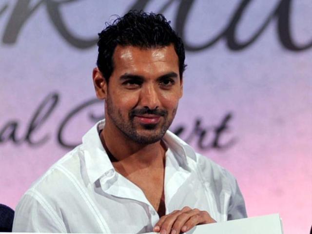 John Abraham looked dashing in a crisp white shirt over blue jeans at an album launch. (Photo/AFP)