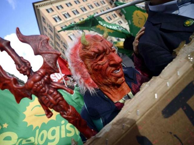 A demonstrator wears a devil's mask during the No Monti Day demonstration in Rome. AFP photo