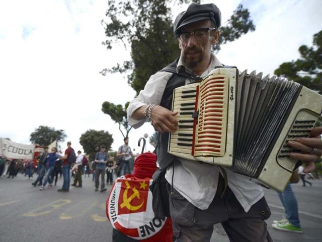 A demonstrator plays accordion during the No Monti Day demonstration in Rome. AFP photo