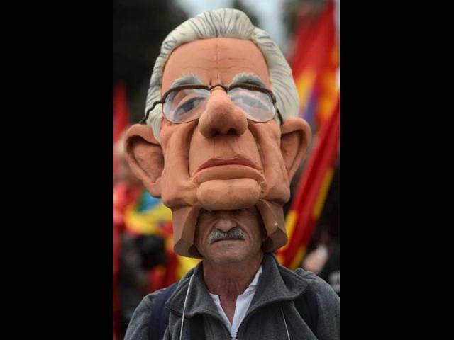 A demonstrator wears a mask of Italian Prime Minister Mario Monti at the start of the No Monti Day demonstration in Rome. AFP photo