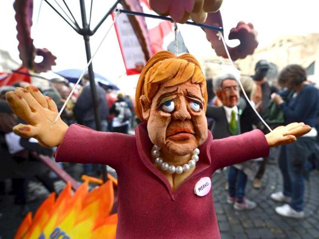 A puppet showing former German Chancellor Angela Merkel is displayed at the start of the No Monti Day demonstration in Rome. AFP photo