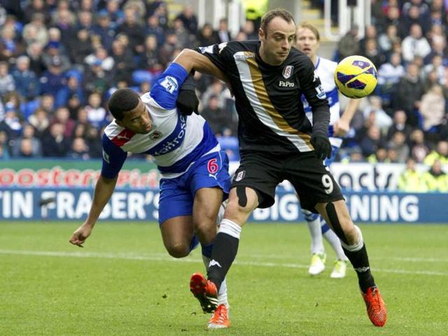 Reading's Adrian Mariappa, left, challenges Fulham's Dimitar Berbatov during their English Premier League soccer match at the Madjeski stadium, in Reading, England. AP Photo