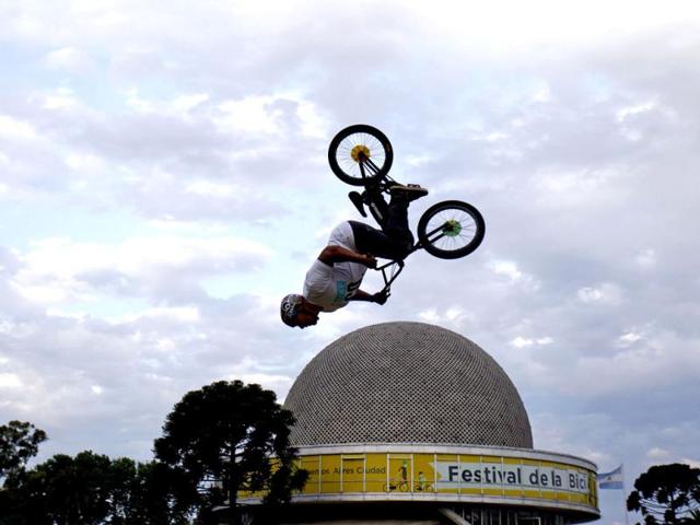 A man performs a trick on a bicycle during a Bicycle Festival outside Buenos Aires' planetarium. Reuters Photo