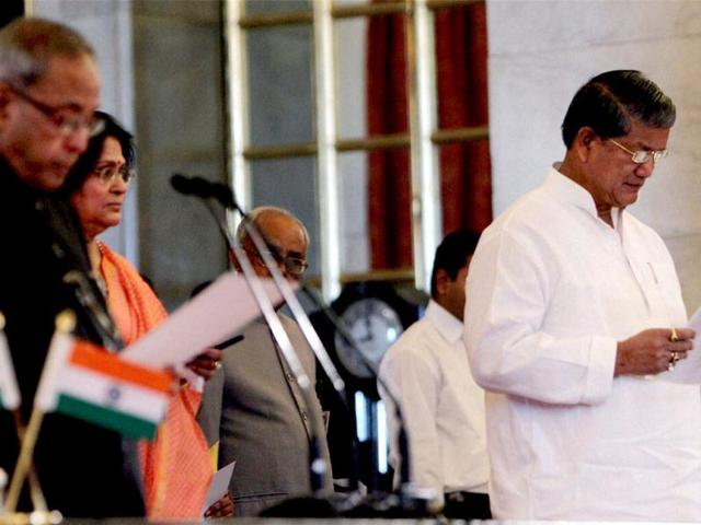 Harish Rawat is sworn-in as a cabinet minister by President Pranab Mukherjee during a ceremony at Rashtrapati Bhavan in New Delhi. PTI Photo
