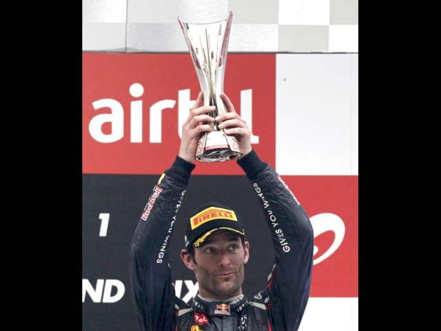 Third placed Red Bull Formula One driver Mark Webber of Australia lifts his trophy during the podium ceremony of the Indian F1 Grand Prix at the Buddh International Circuit in Greater Noida. Reuters