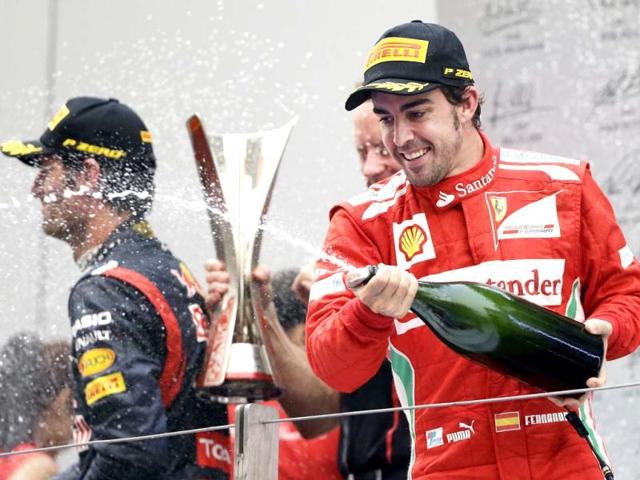 Ferrari driver Fernando Alonso of Spain celebrates on the podium after finishing second in the Indian Formula One Grand Prix, at the Buddh International Circuit in Greater Noida. AP Photo
