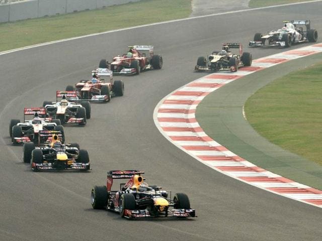 Red Bull-Renault driver Sebastian Vettel of Germany (C) leads followed by teammate Red Bull-Renault driver Mark Webber of Australia (CL) during the Formula One Indian Grand Prix in Greater Noida. AFP Photo
