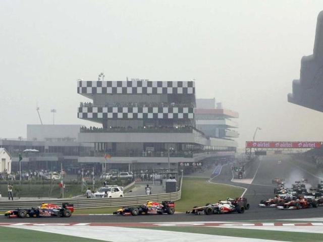 Red Bull Formula One driver Sebastian Vettel (L) of Germany leads on the first turn of the Indian F1 Grand Prix at the Buddh International Circuit in Greater Noida. Reuters