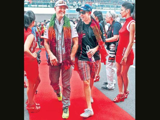 Michael Schumacher and Sebastian Vettel after the drivers’ parade at the Indian F1 Grand Prix at the Buddh International Circuit in Greater Noida. PTI photo