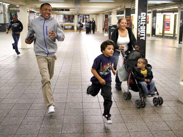 A family runs for the last subway shuttle to Grand Central Station in New York in anticipation of Hurricane Sandy. Reuters
