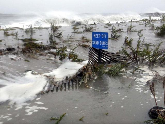 Rough surf of the Atlantic Ocean breaks over the dunes in Cape May, New Jersey, as high tide and Hurricane Sandy begin to arrive. AP Photo