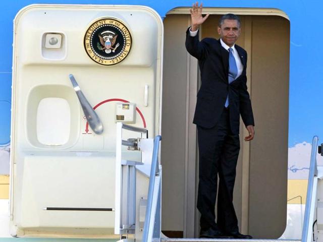 President Barack Obama waves as he boards Air Force One before departing the Orlando International Airport in Orlando, Florida enroute to Washington to monitor Hurricane Sandy. AP Photo
